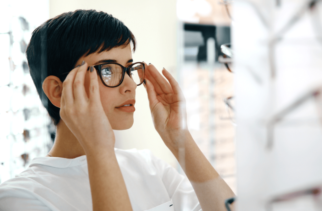 A woman trying on new glasses at the optometrist office