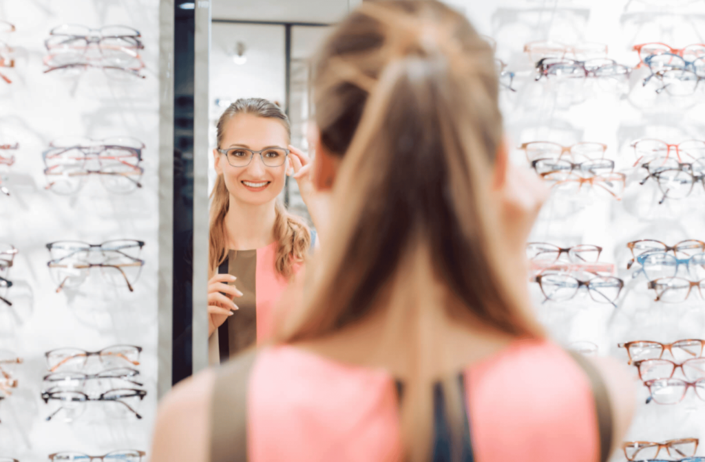 A woman tries on a pair of glasses at the optometrist's office